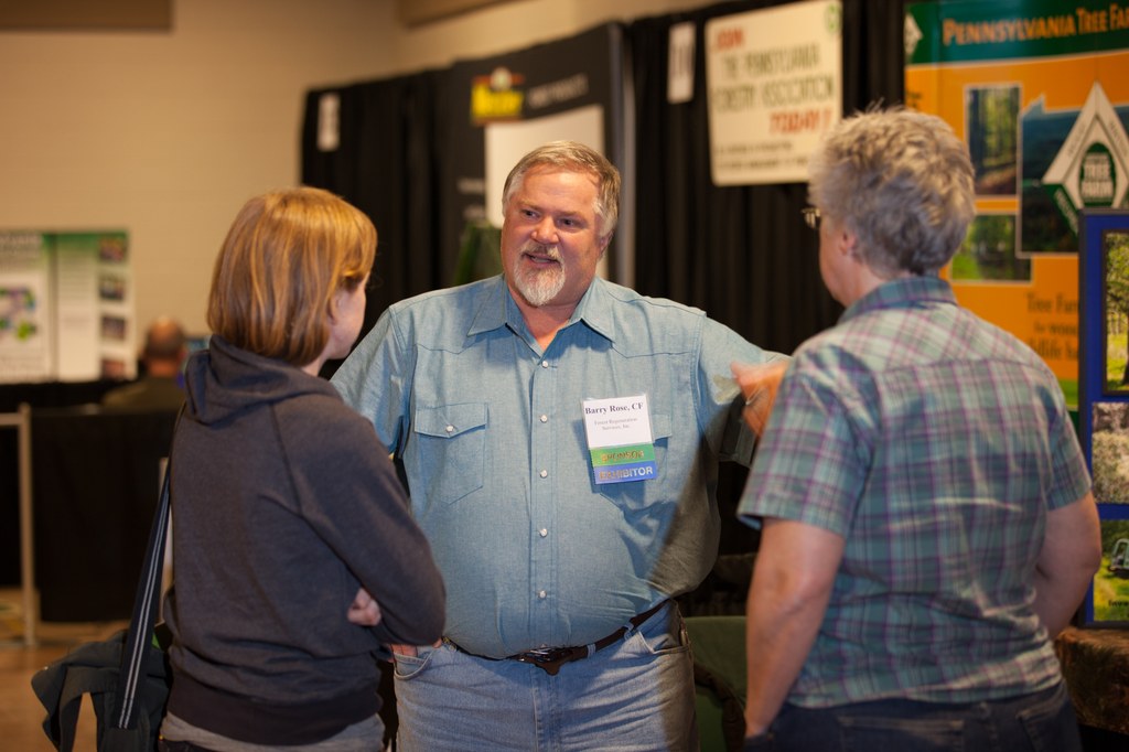 Exhibit hall vendor sharing resources with a conference guest