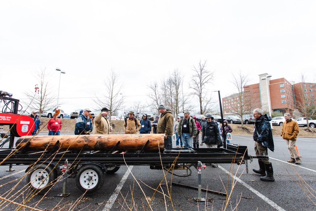 Penn State Department of Ecosystem Science and Management instructor, Mike Powell, shows a freshly cut log loaded on a portable sawmill. Photo credit: Laura Kirt Studios