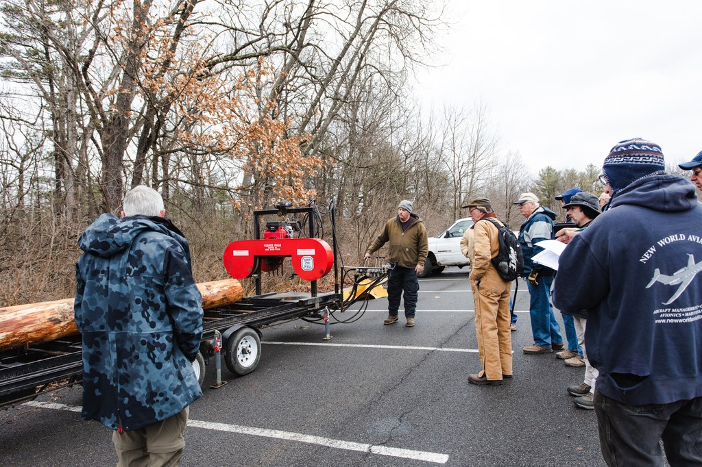 Mike Powell, Instructor, Penn State Department of Ecosystem Science and Management, discusses the use of a portable sawmill with the tree he just fell.  Photo credit: Laura Kirt Studios