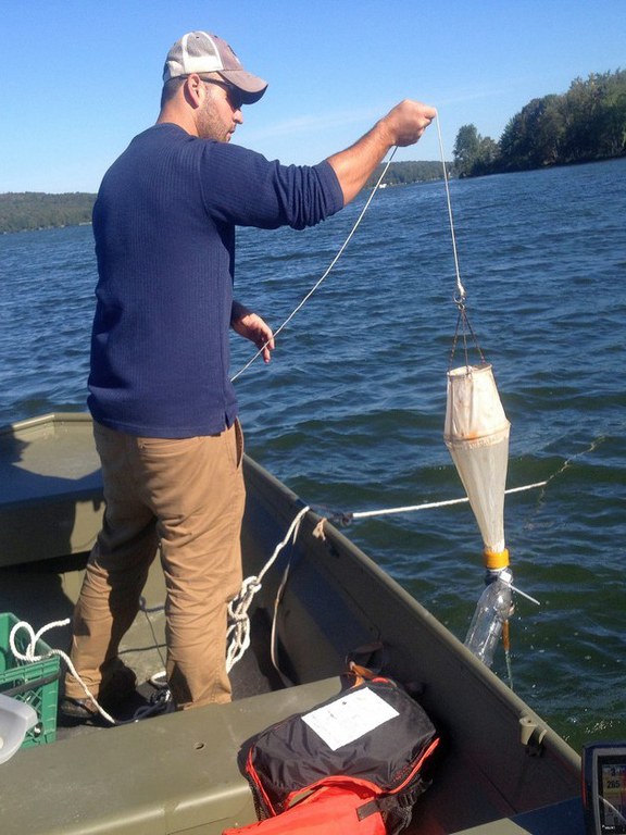 Josh Mulhollem uses zooplankton nets to monitor the larval form of invasive zebra and quagga mussels and to check for the presence of spiny waterflea, an invasive zooplankton recently discovered in Lake Champlain.  Image: Courtesy of Josh Mulhollem